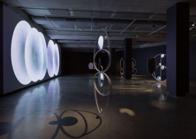 A gallery shot of Lisa Sammut's three sculptures showing Hailey comets orbit and a large projection of the moon's orbit