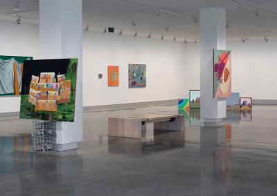 inside a contemporary art gallery with paintings on the walls and columns
