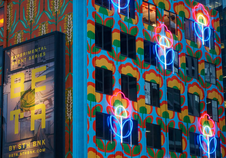 A building with neon art projected on walls