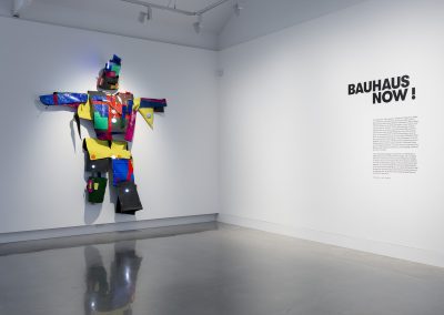 Gallery entrance with colourful artwork of a person made of mixed media