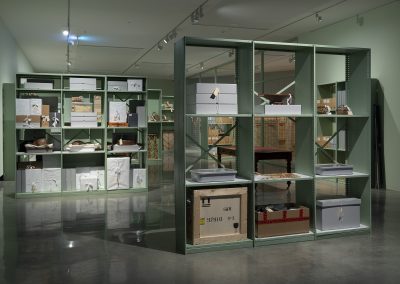 cabinets of collection boxes and objects in a gallery