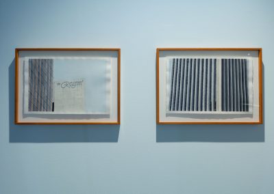 Two framed artworks of the Regent hotel on a blue wall