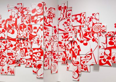 A series of red and white paintings pieced together to make one artwork